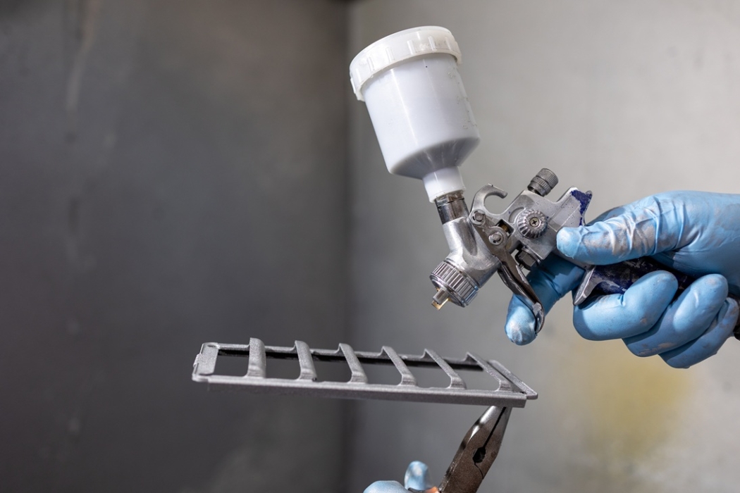 Additive manufactured component about to be spray painted