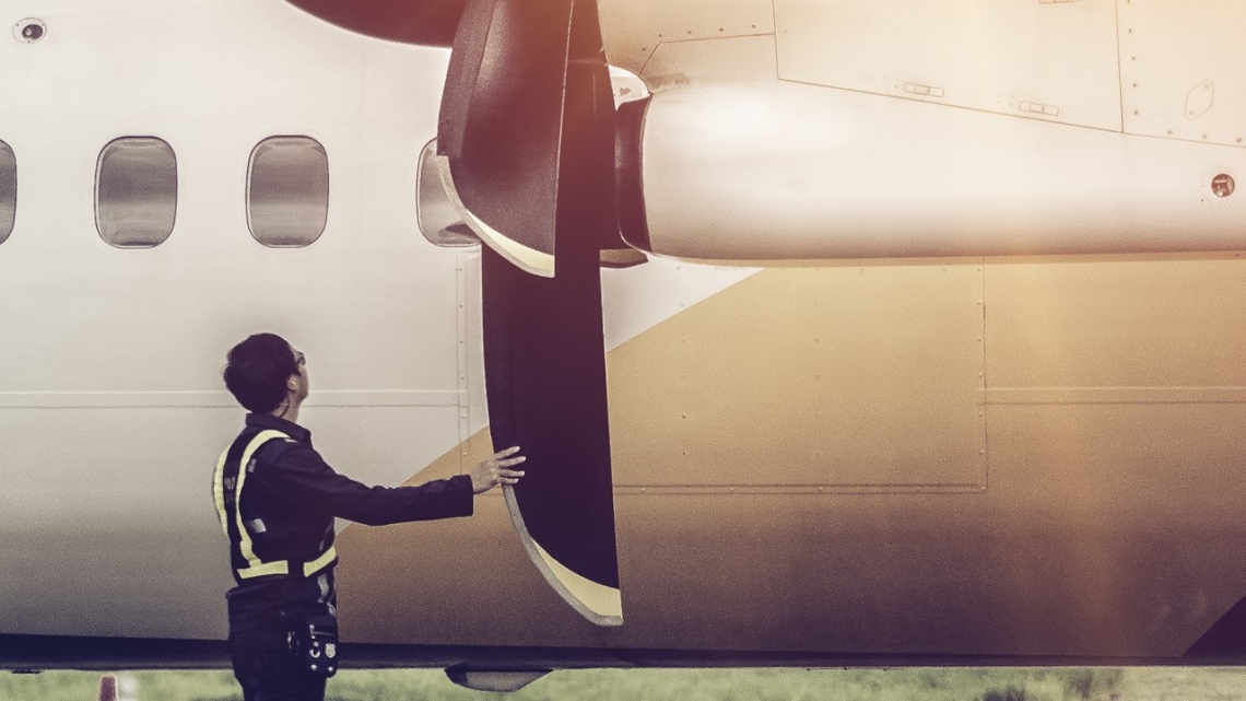 Person inspecting a composite propeller